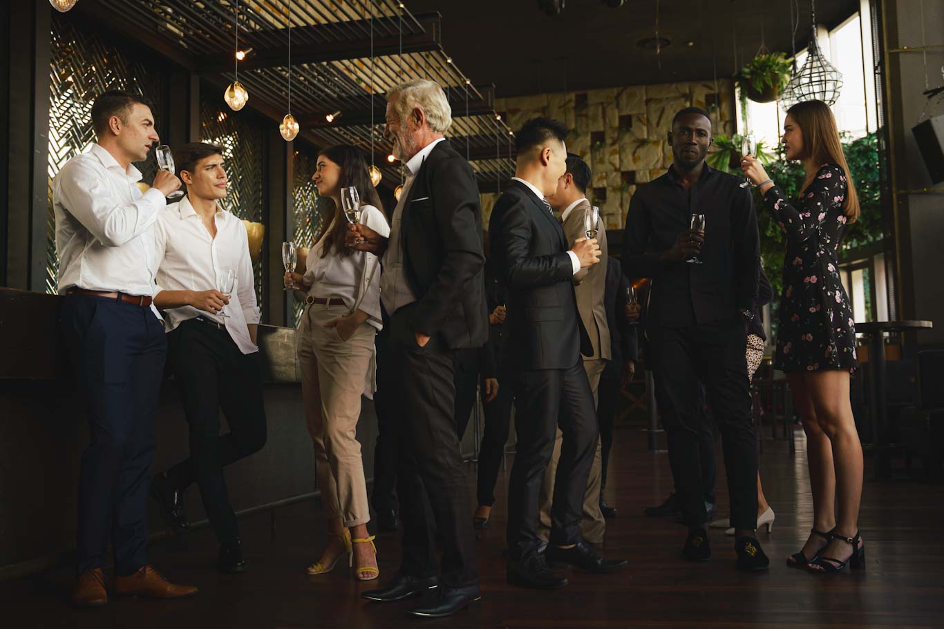 Group of people socializing at an indoor event, ideal for Tampa wedding videographer services.