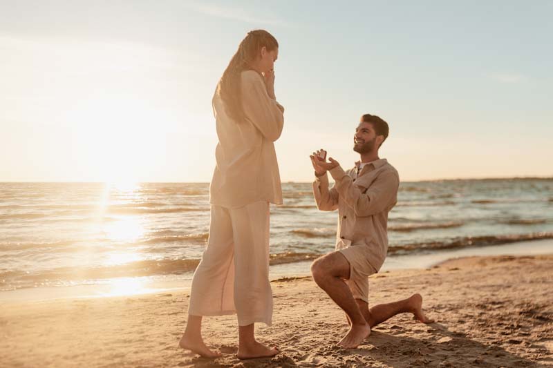 Beach proposal at sunset, perfect for engagement videos Tampa by a skilled Tampa wedding videographer.